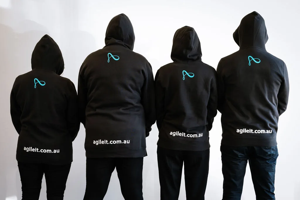 The Agile IT team photographed from behind, looking out together, the people who have your back.
