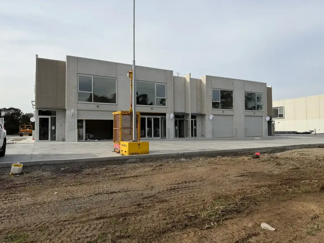 Wider view of the Free Form development at an earlier stage, concrete walls up, windows installed, surrounding dirt still raw