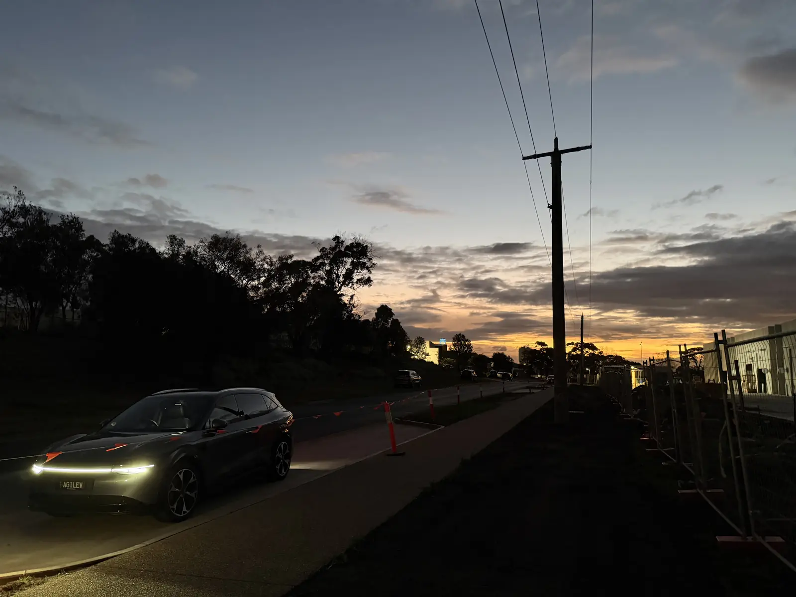 Sunset over the Free Form development with a car parked alongside, golden light, end of the working day