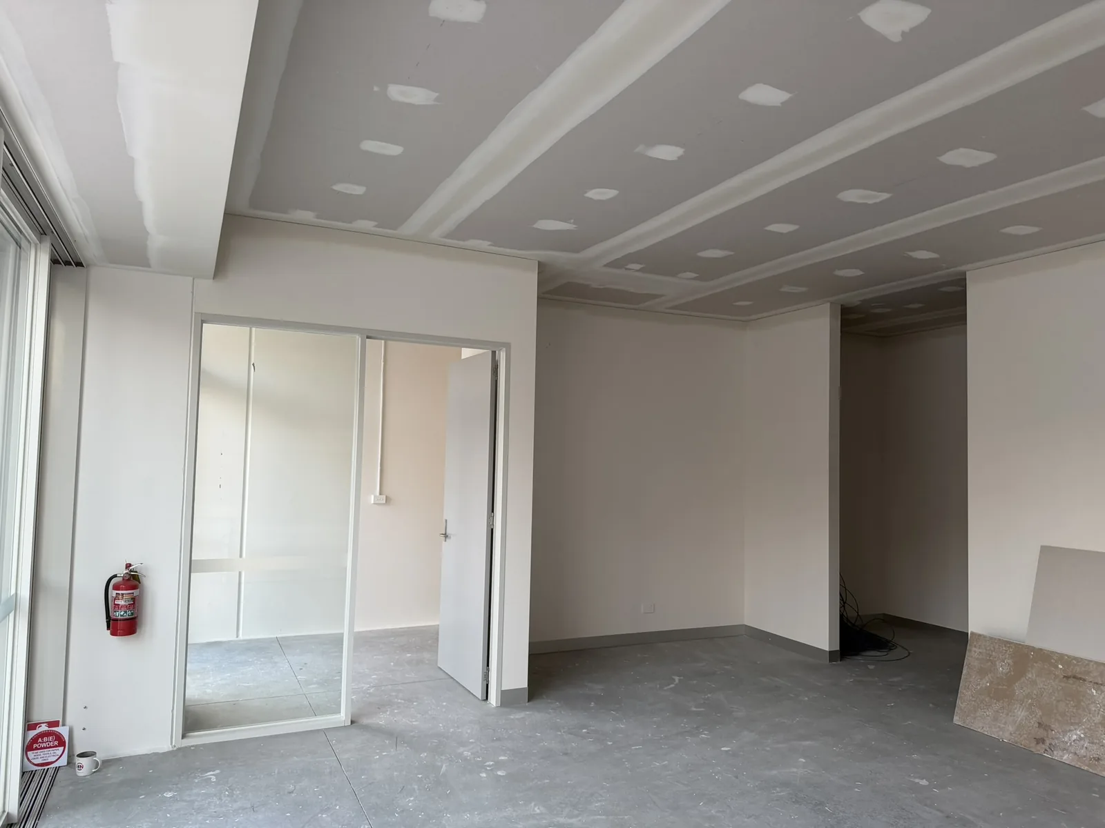The downstairs space at Free Form, Mornington still being finished, set but unpainted plasterboard ceiling and a bare concrete floor