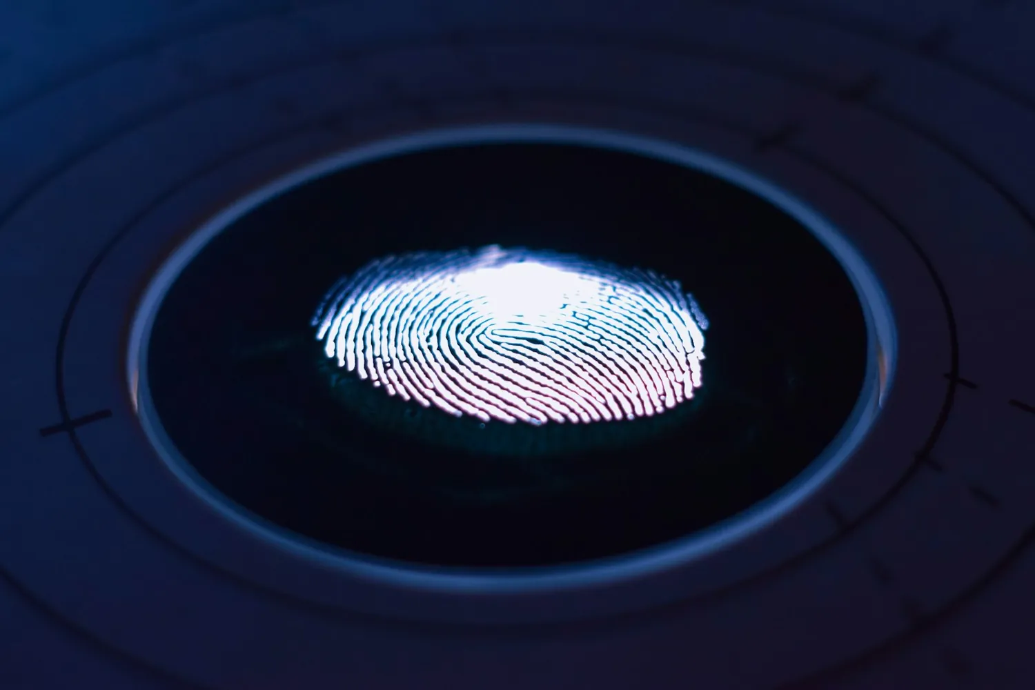 A glowing blue fingerprint scanner, representing secure access and the layered protection of AgileSECURE under the SMB1001 framework.