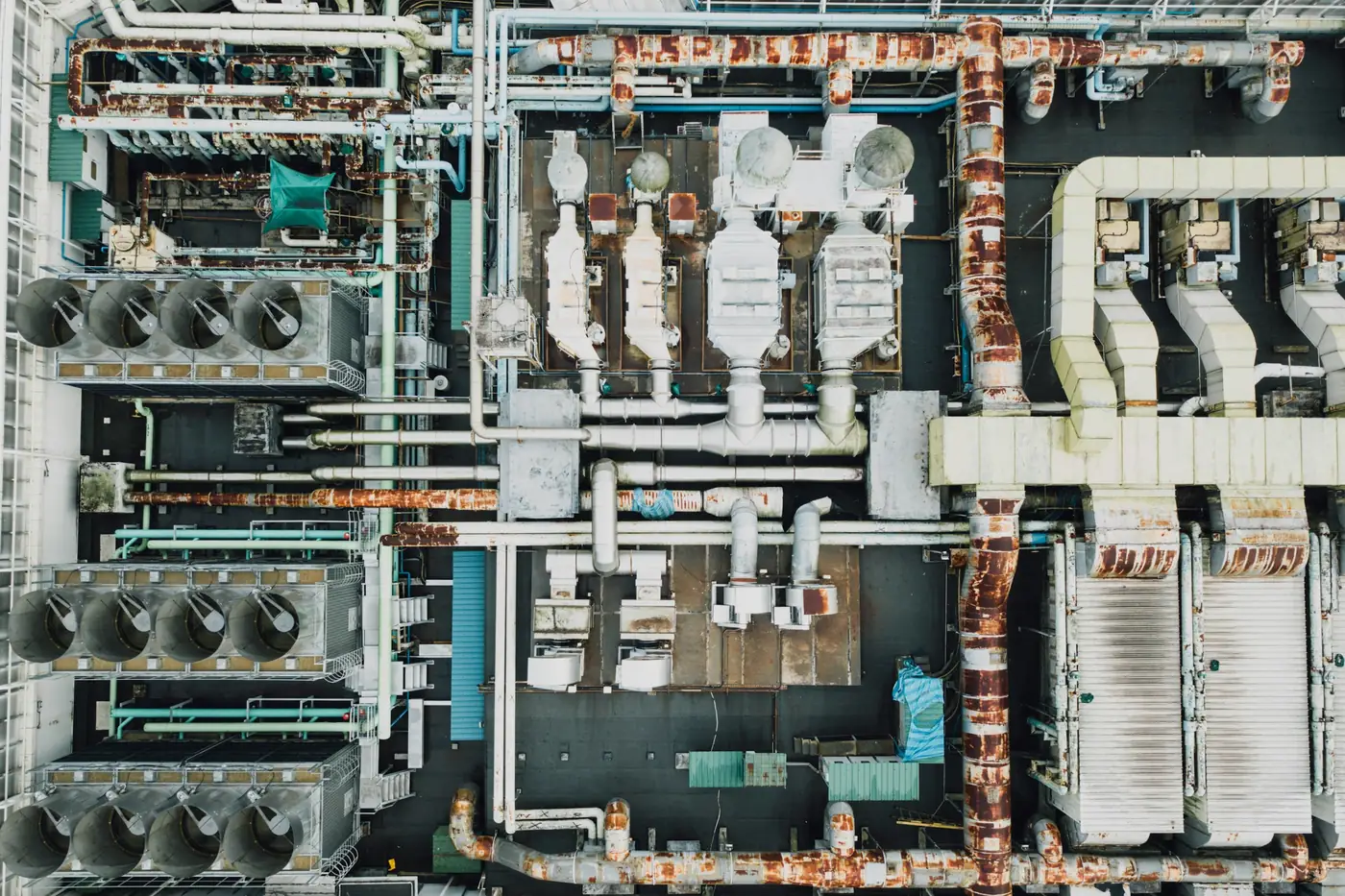 An industrial plant photographed from directly above, showing its pipework, ducting and roof-mounted plant