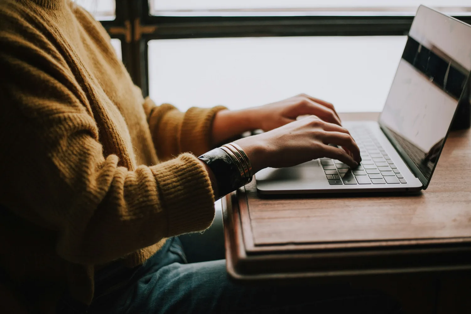 A person signing in on a laptop, using a passkey rather than typing a password.