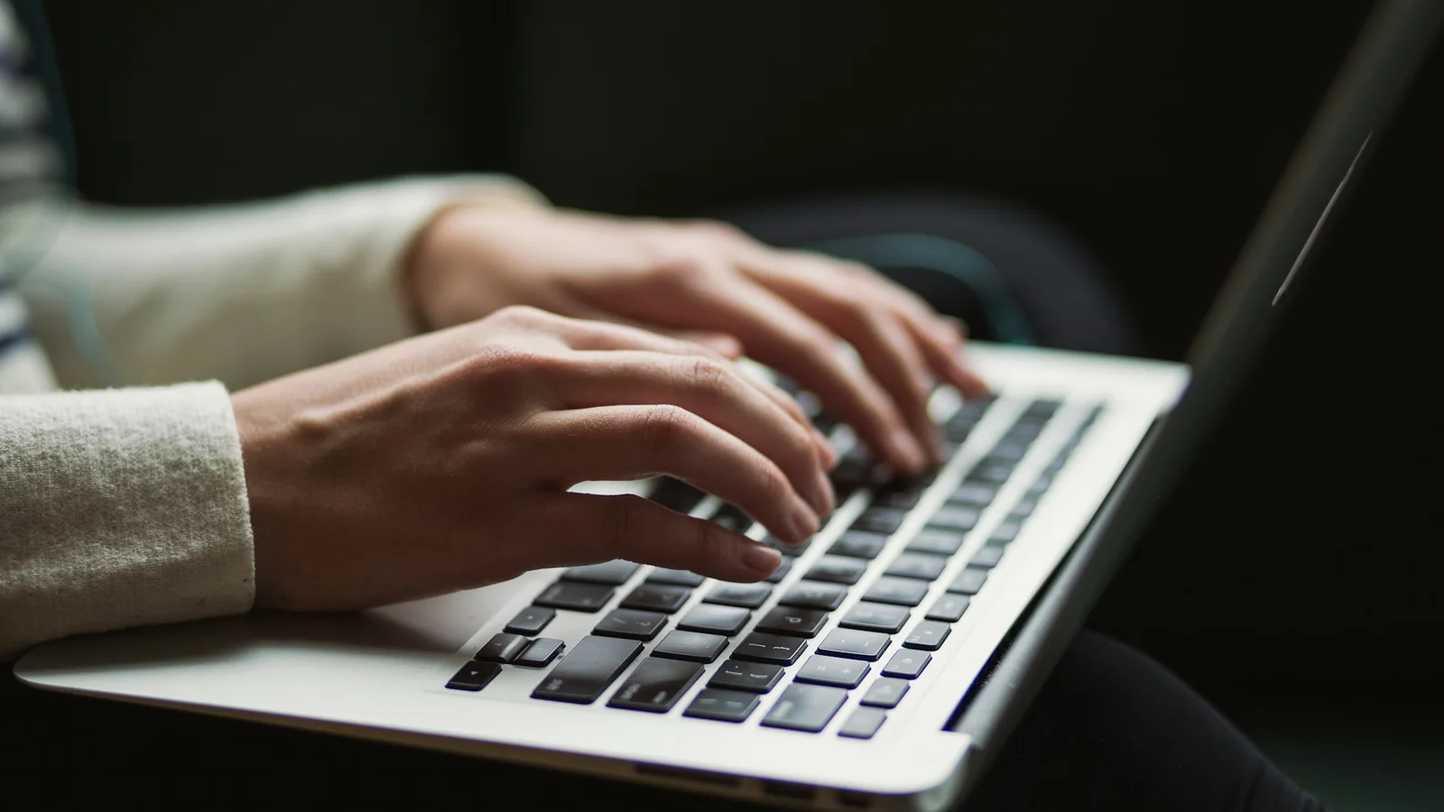 A person working at a laptop, the day-to-day operational discipline that turns cyber security tools into a working posture. Photo by Kaitlyn Baker on Unsplash.